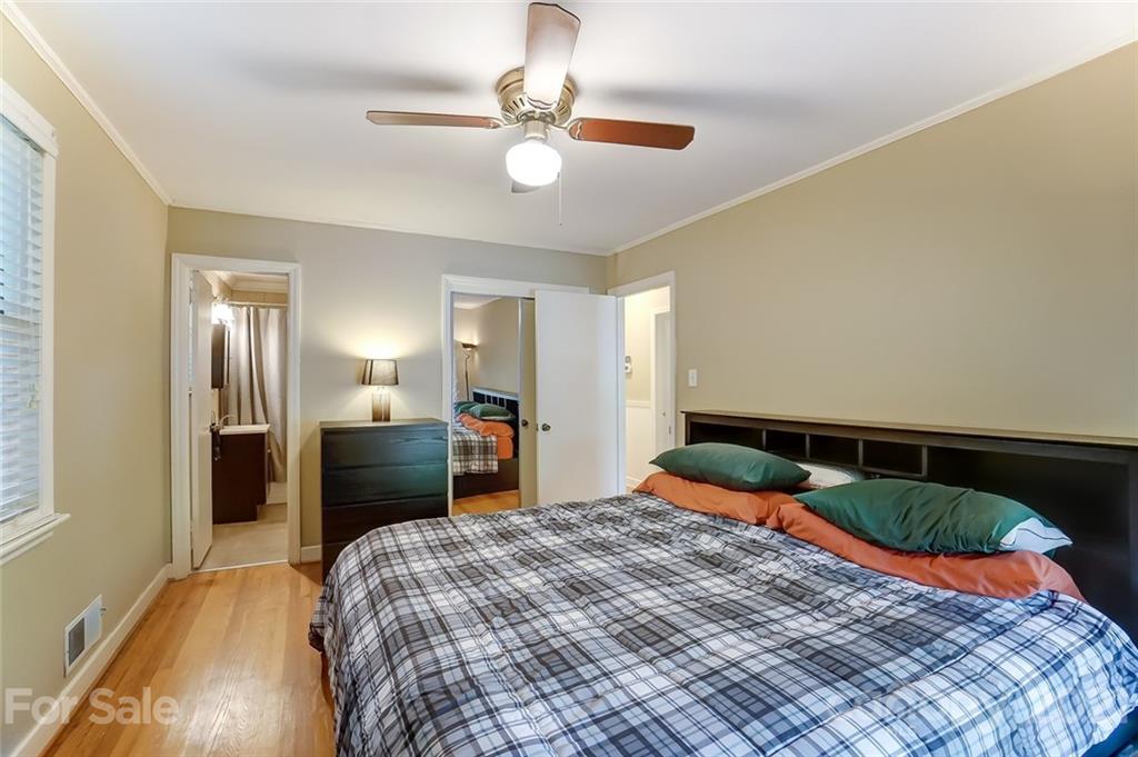 4460 Applegate Road Charlotte, NC 28209 - Photo 18 of 41 a bedroom with a bed and a chandelier