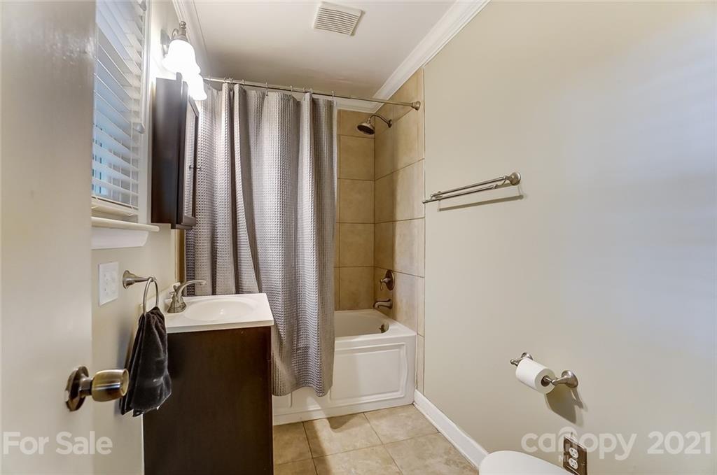 4460 Applegate Road Charlotte, NC 28209 - Photo 19 of 41 a bathroom with a sink toilet and shower