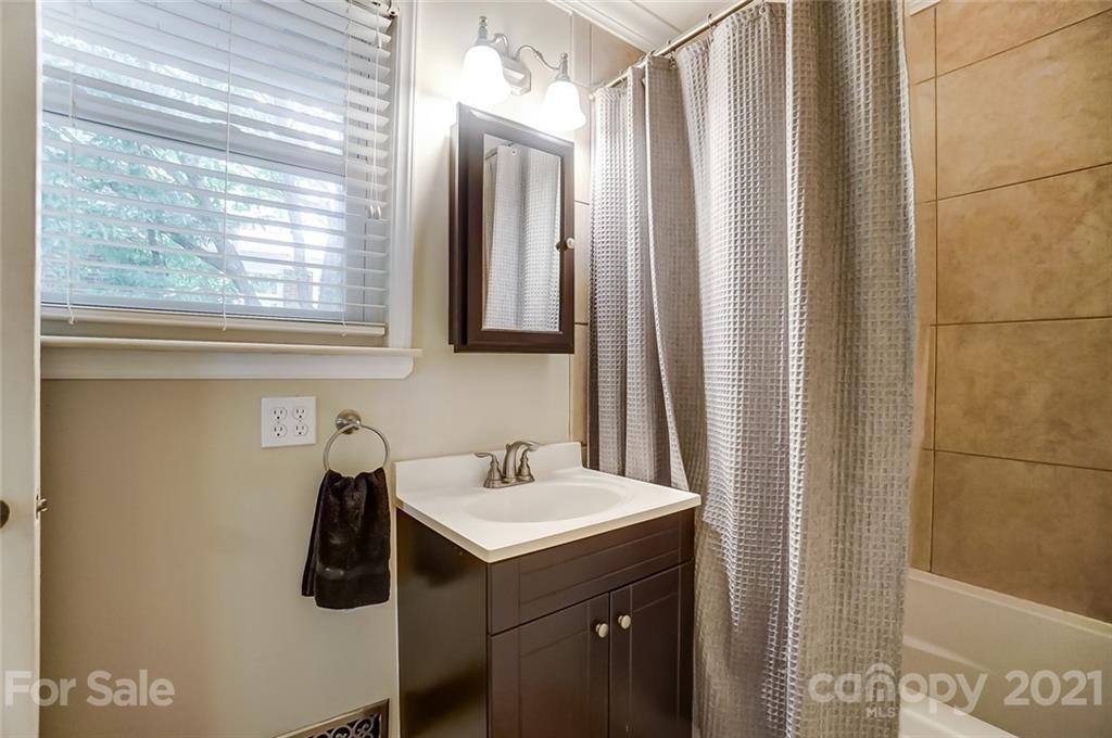 4460 Applegate Road Charlotte, NC 28209 - Photo 20 of 41 a bathroom with a sink and a mirror
