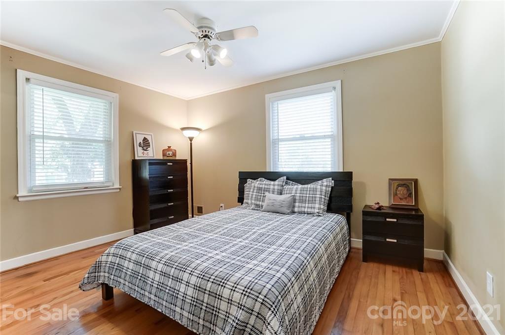 4460 Applegate Road Charlotte, NC 28209 - Photo 21 of 41 a bedroom with a bed and wooden floor