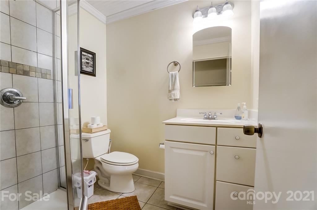 4460 Applegate Road Charlotte, NC 28209 - Photo 25 of 41 a bathroom with a toilet a sink and mirror