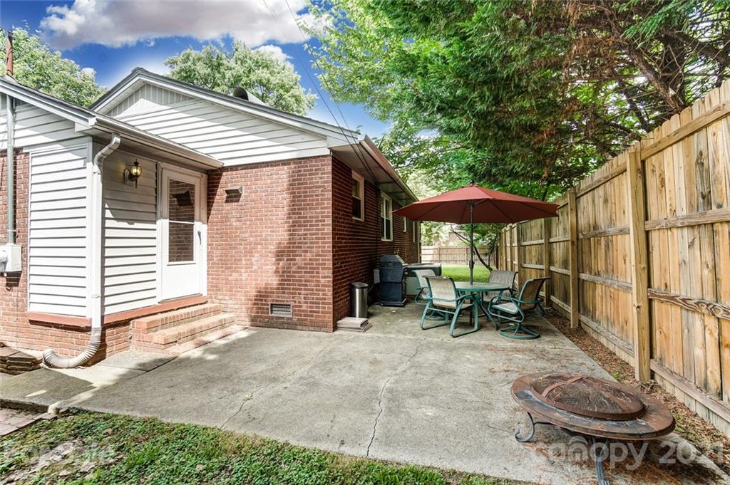 4460 Applegate Road Charlotte, NC 28209 - Photo 28 of 41 a backyard of a house with table and chairs