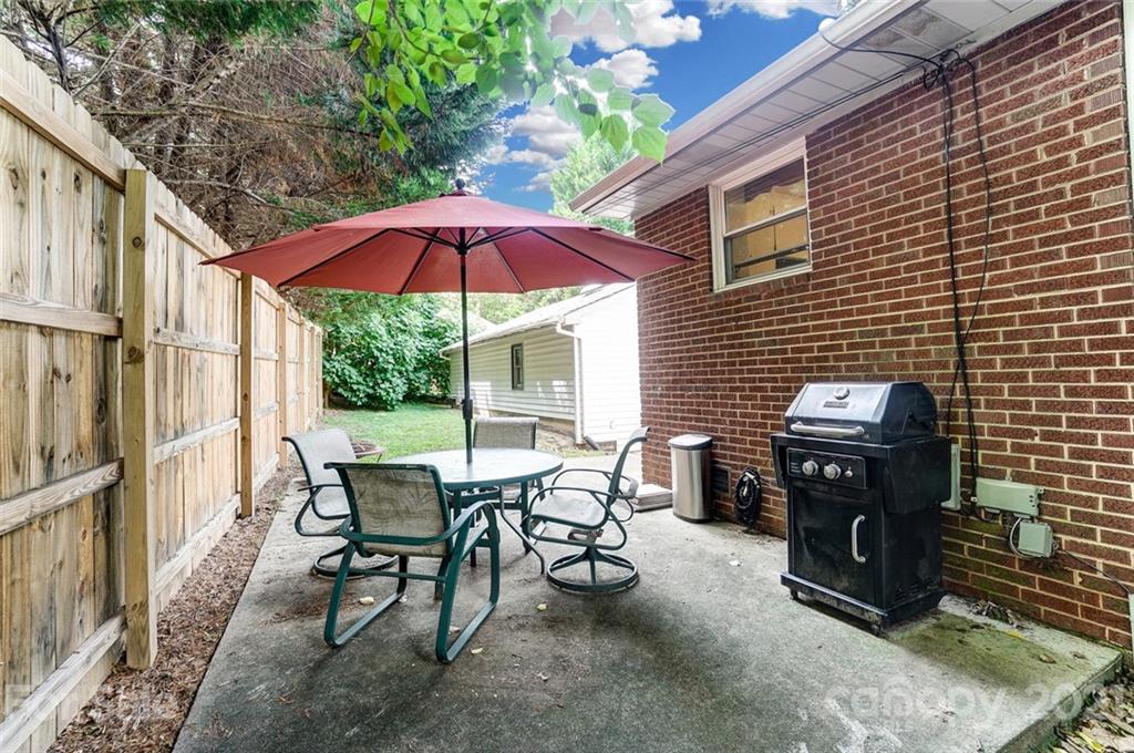 4460 Applegate Road Charlotte, NC 28209 - Photo 30 of 41 a view of a patio with table and chairs under an umbrella