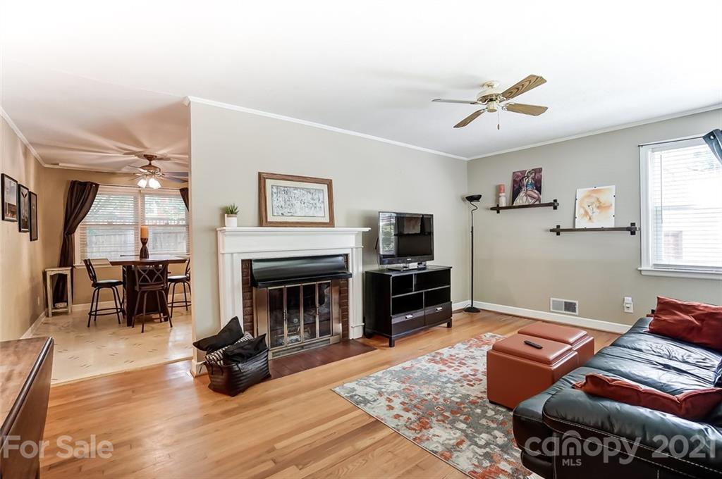 4460 Applegate Road Charlotte, NC 28209 - Photo 6 of 41 a living room with furniture a fireplace and a flat screen tv