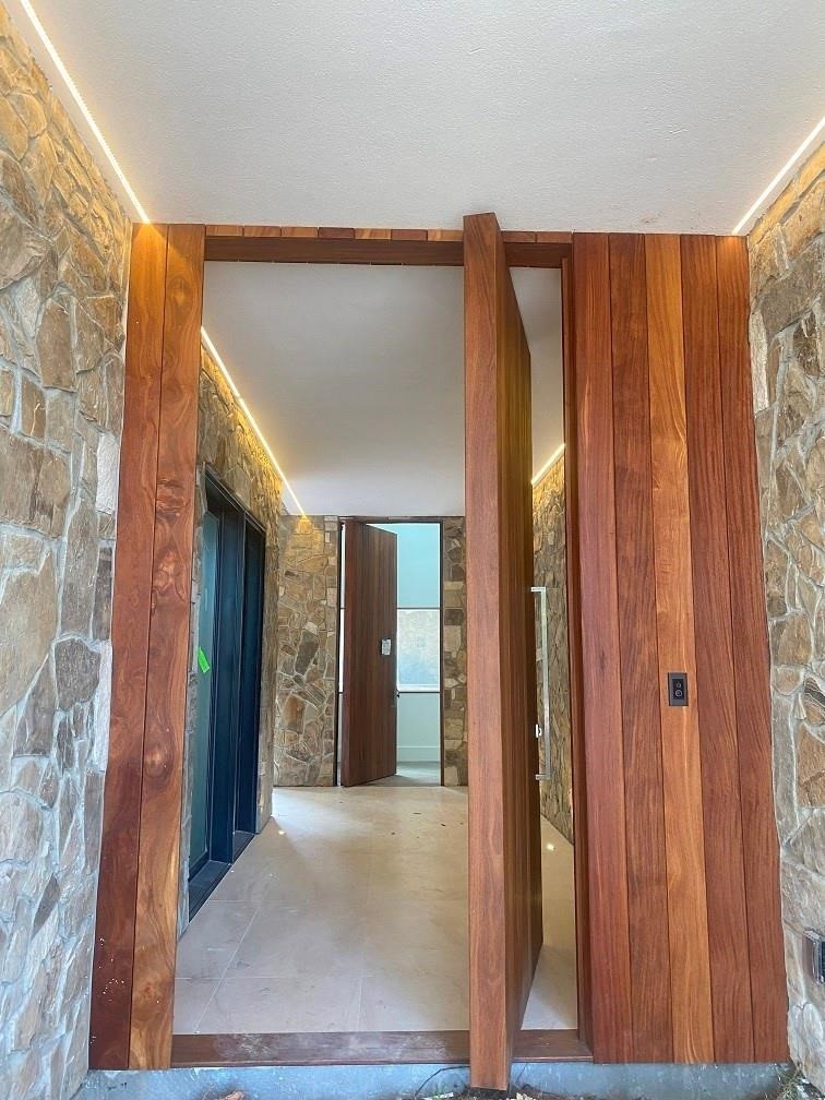 12815 Hansel Lane Houston, TX 77024 - Photo 2 of 5 a view of a hallway with wooden shelves