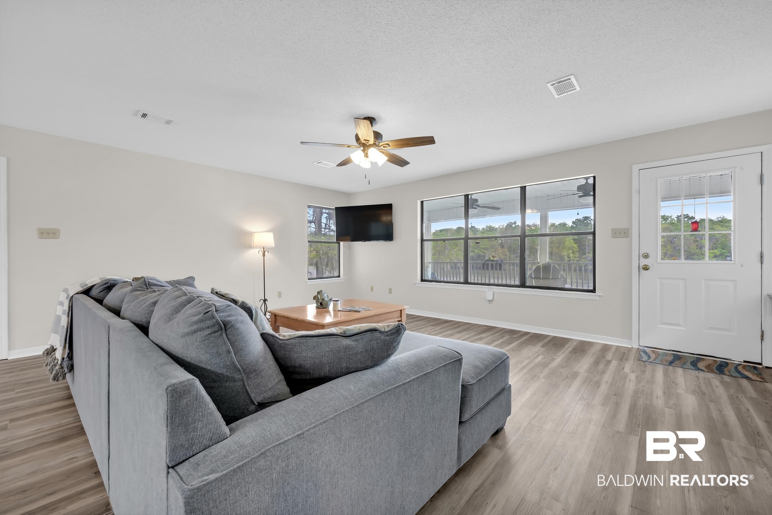 8081 Bryant's Lndg Road Stockton, AL 36579 - Photo 18 of 48 Living area with light wood finished floors, a ceiling fan, and a textured ceiling