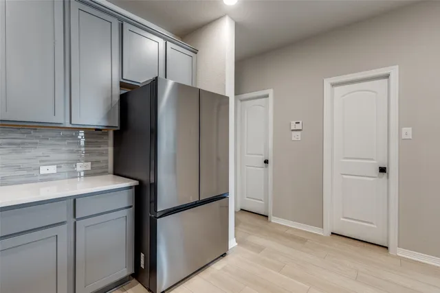 a kitchen with a refrigerator and a sink