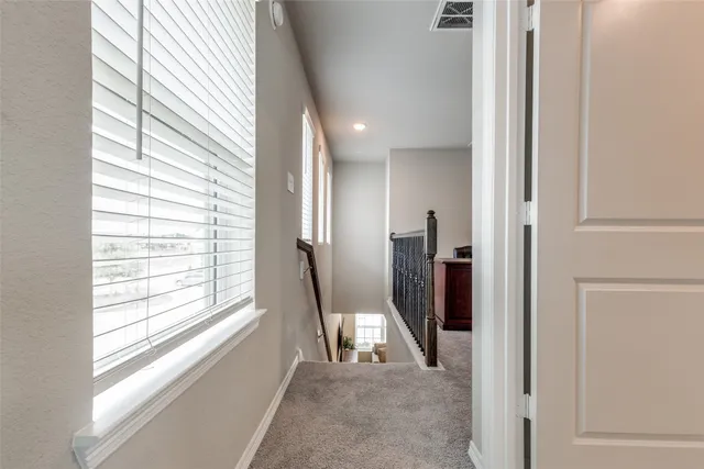 a view of a hallway with windows