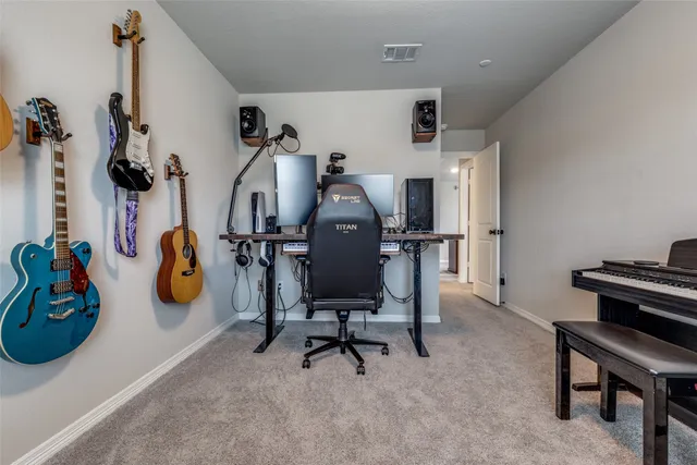 a view of workspace with furniture and gym equipment