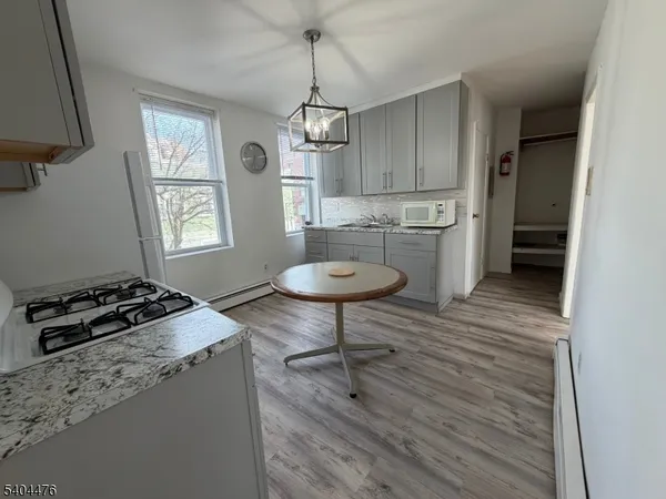 a kitchen with stainless steel appliances a stove a refrigerator and cabinets