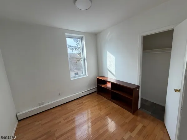 a room with window and a dresser