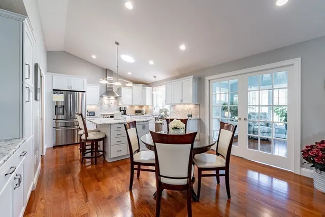 a view of a dining room with furniture and wooden floor