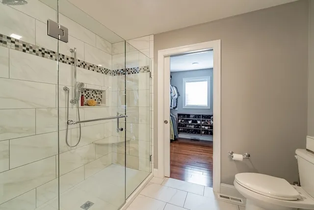 a bathroom with a shower and a toilet
