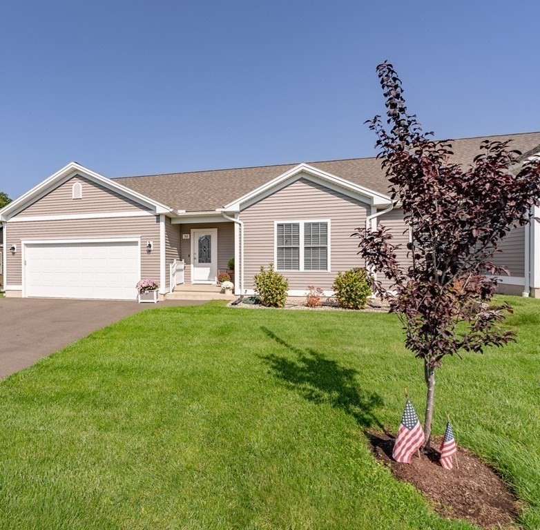 308 Miller Street, Unit 79 Ludlow, MA 01056 - Photo 2 of 20 a front view of a house with a yard