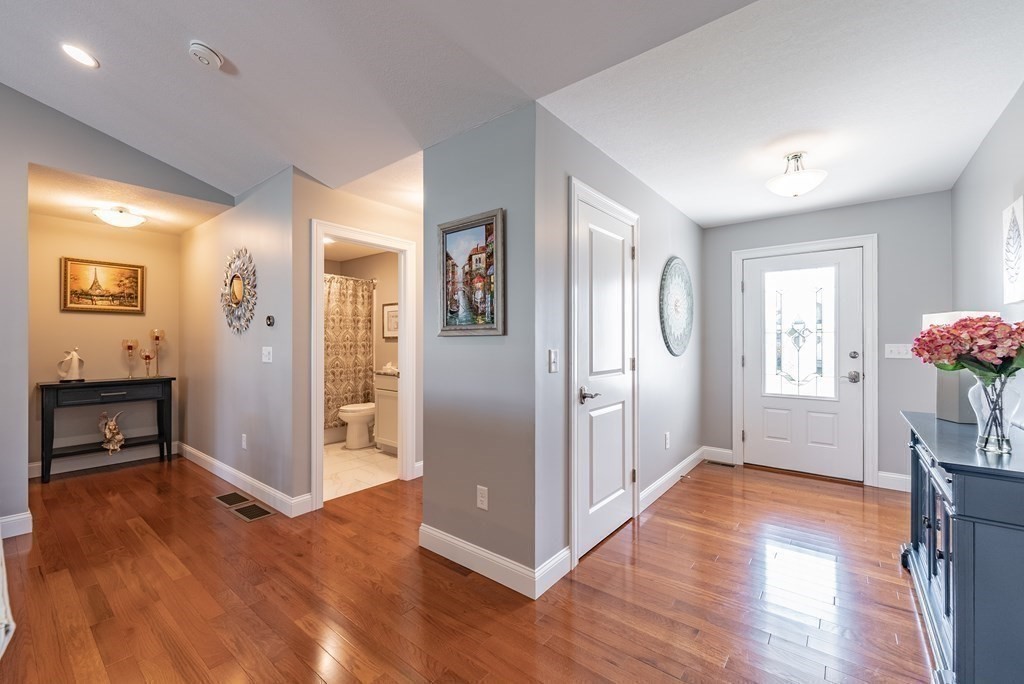 308 Miller Street, Unit 79 Ludlow, MA 01056 - Photo 3 of 20 a view of a hallway with wooden floor and a dining room