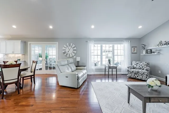a living room with furniture and wooden floor