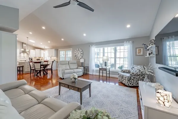 a living room with furniture and wooden floor