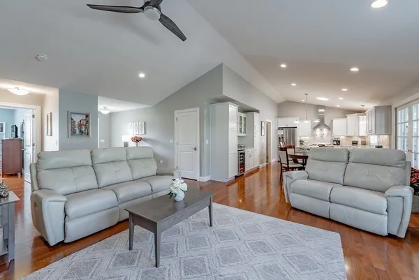 a living room with furniture and a wooden floor
