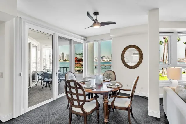 a view of a balcony with table and chairs and a potted plant