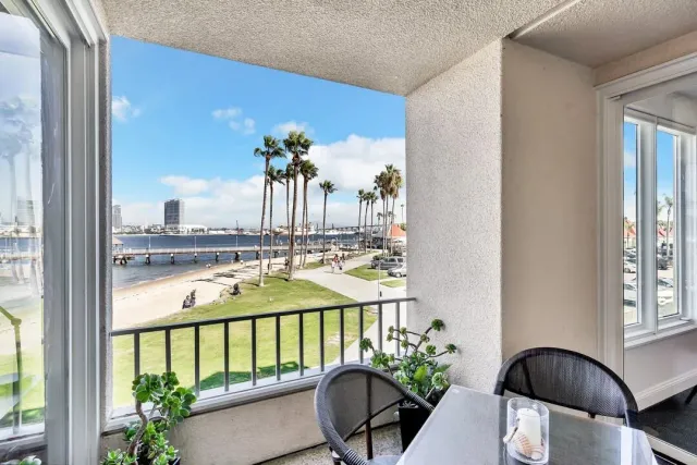 a dining room with furniture a window and wooden floor