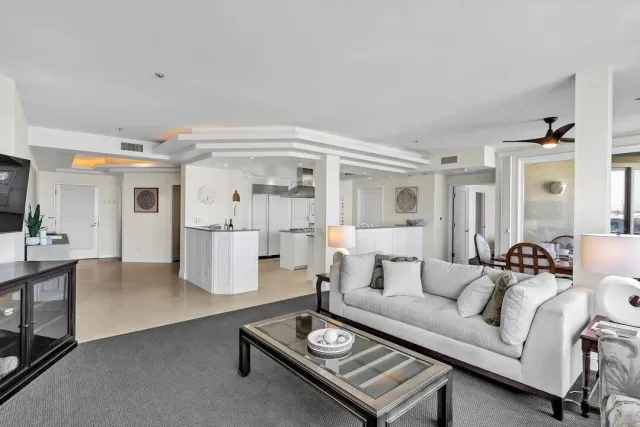 a bathroom with a granite countertop sink a toilet a shower and a mirror