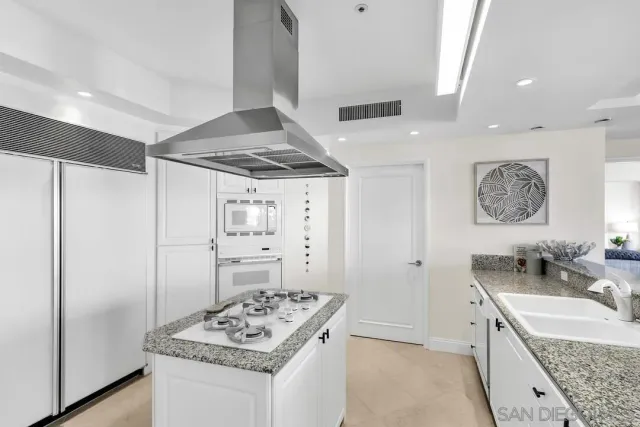 a bedroom with a bed a large window and walk in closet