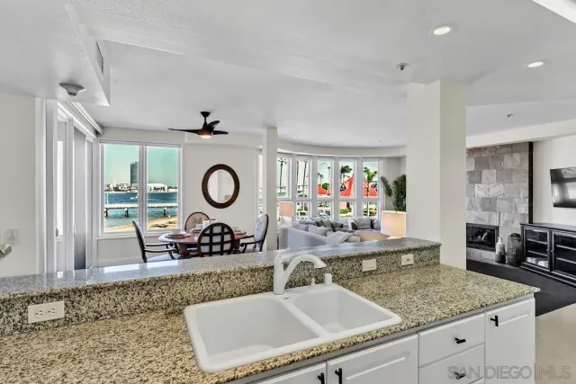 a large white kitchen with a sink and cabinets