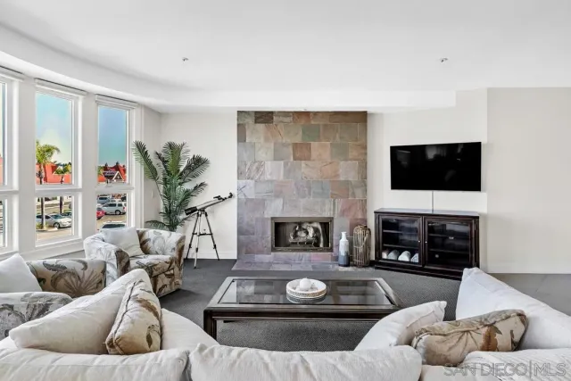 a view of a livingroom with furniture and a large window