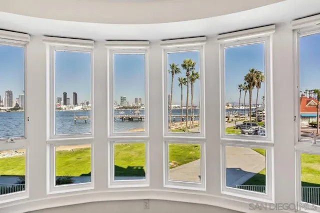 a spacious bathroom with a double vanity sink a mirror a bathtub and a window