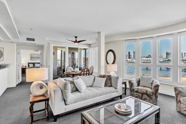 a view of a dining room with furniture and a large window