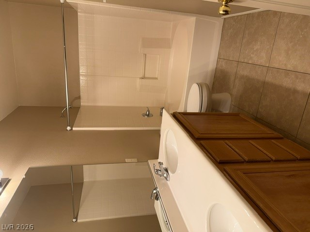 1132 Cathedral Ridge Street Henderson, NV 89052 - Photo 9 of 13 A well-maintained bathroom offers a practical shower-tub combination and a dual-sink vanity with warm wood cabinetry.