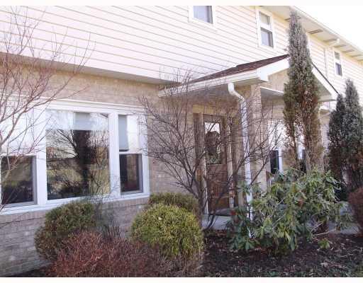 Exterior Front. New Windows throughout the home are framed with Oak;  This Window is the Formal Living Room