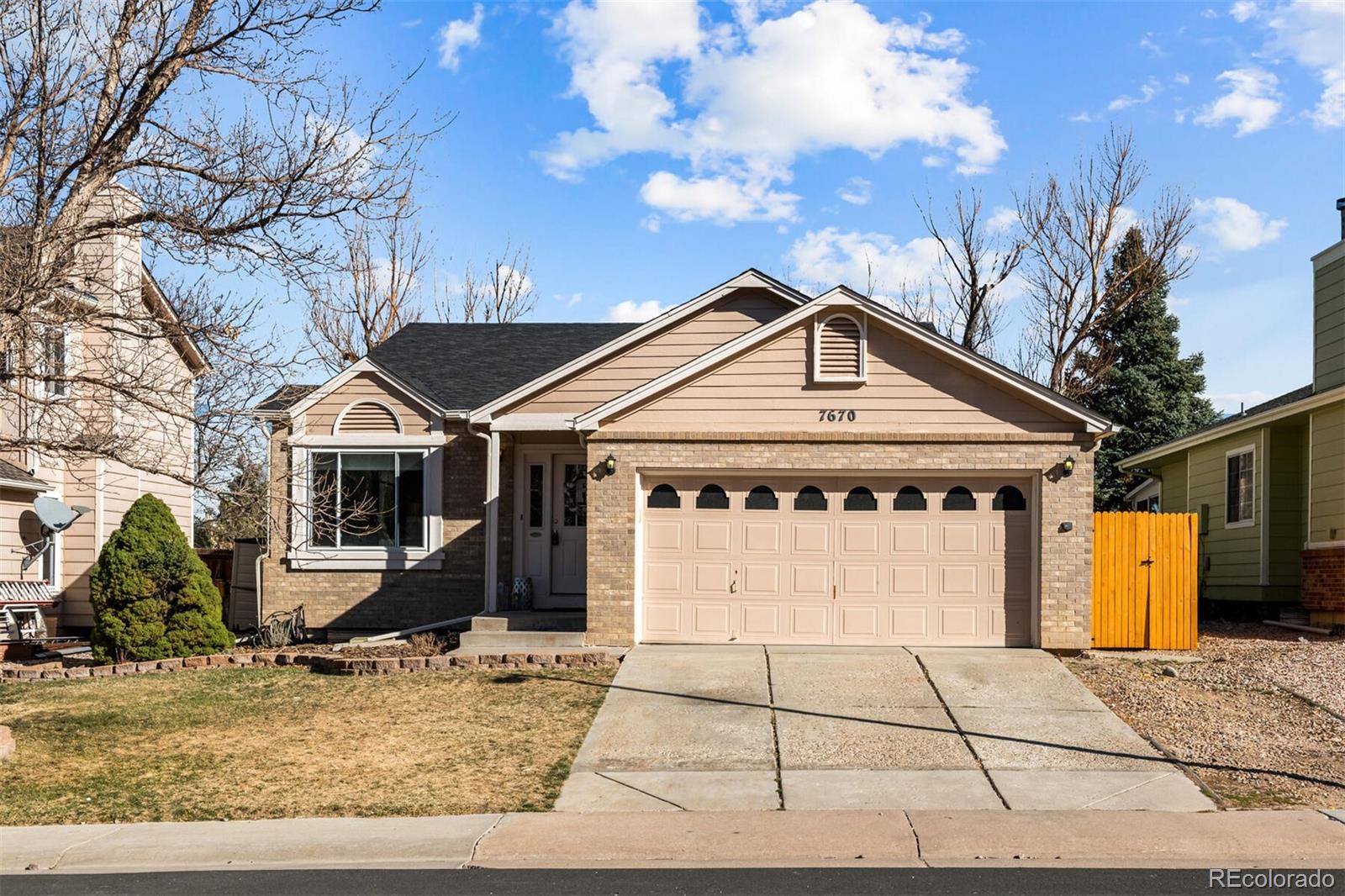 7670 Jared Way Littleton, CO 80125 - Photo 1 of 34 a front view of a house with garden