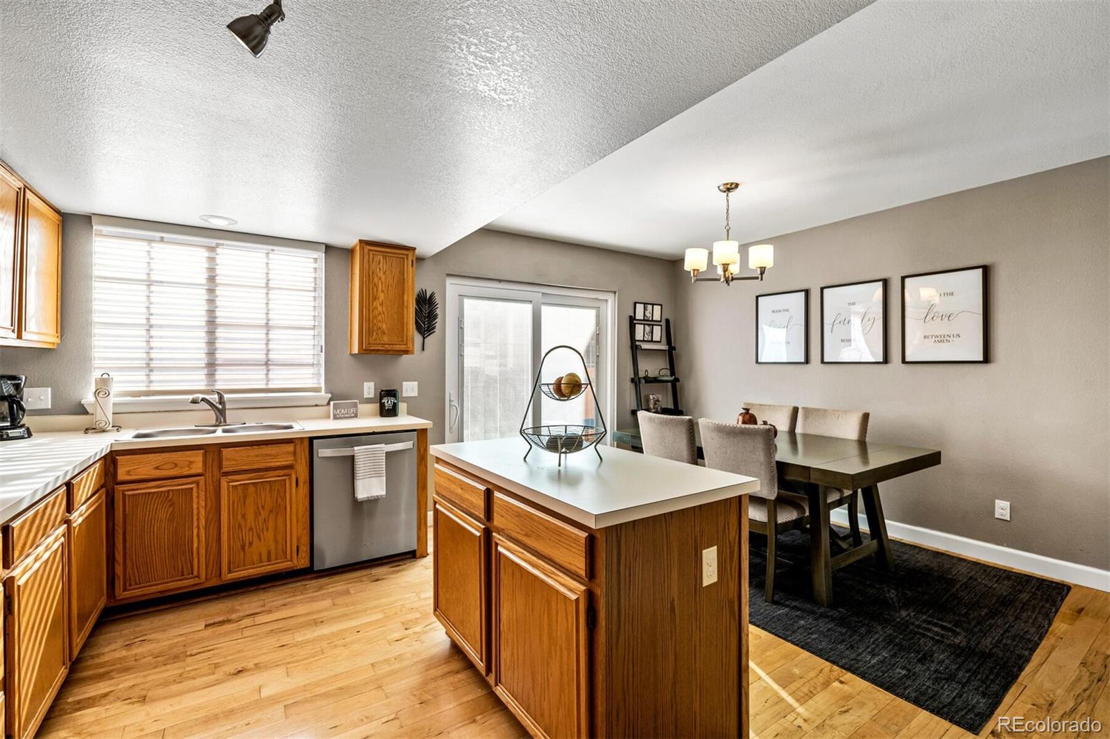 7670 Jared Way Littleton, CO 80125 - Photo 13 of 34 a kitchen with granite countertop a sink stove and cabinets