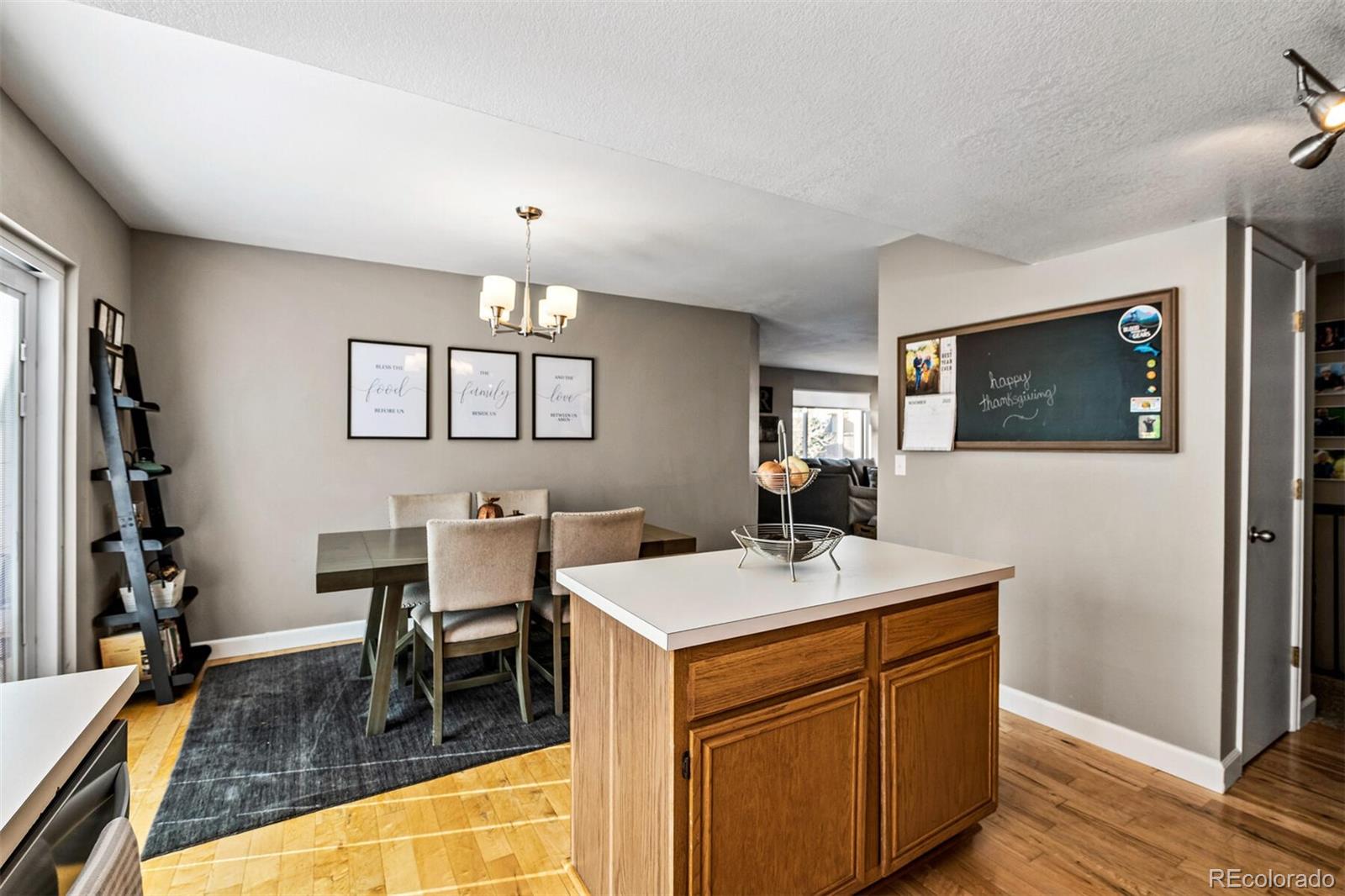 7670 Jared Way Littleton, CO 80125 - Photo 14 of 34 a kitchen that has a sink a table and chairs in it