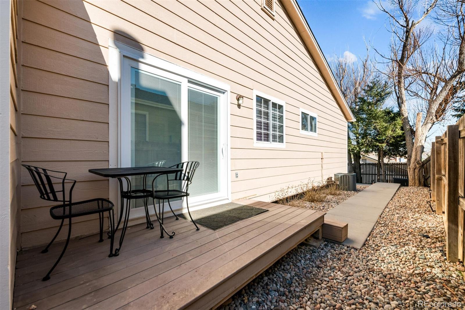 7670 Jared Way Littleton, CO 80125 - Photo 27 of 34 a view of a wooden chairs on the deck