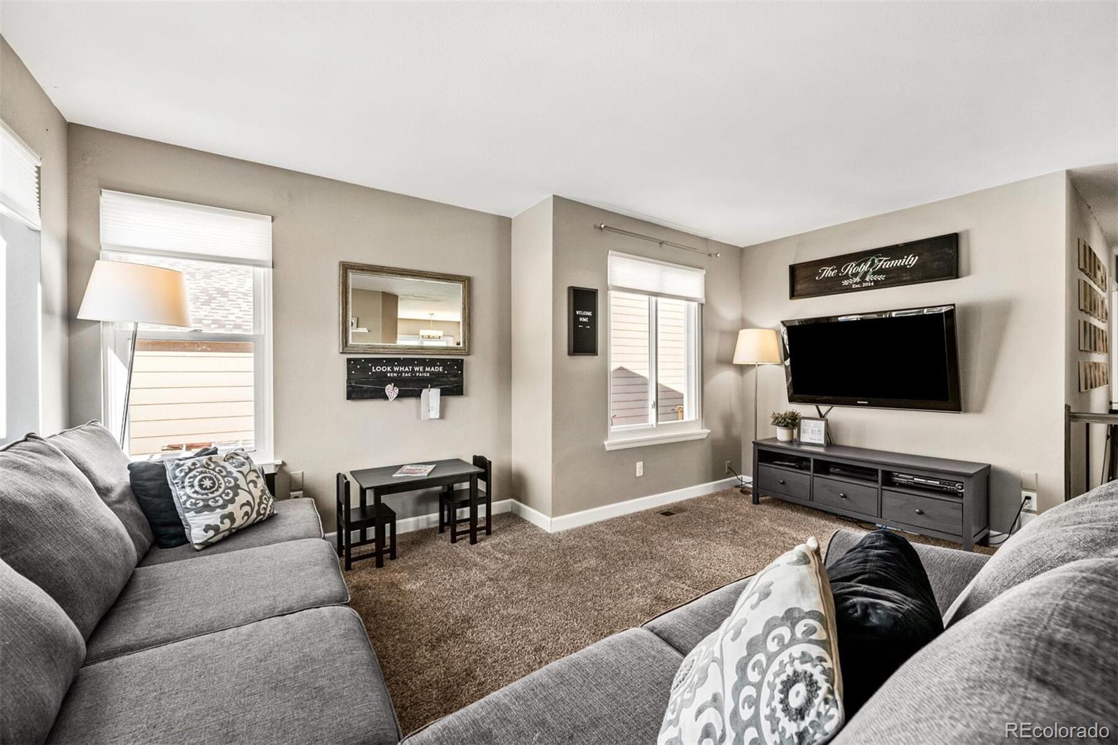 7670 Jared Way Littleton, CO 80125 - Photo 5 of 34 a living room with furniture and a flat screen tv