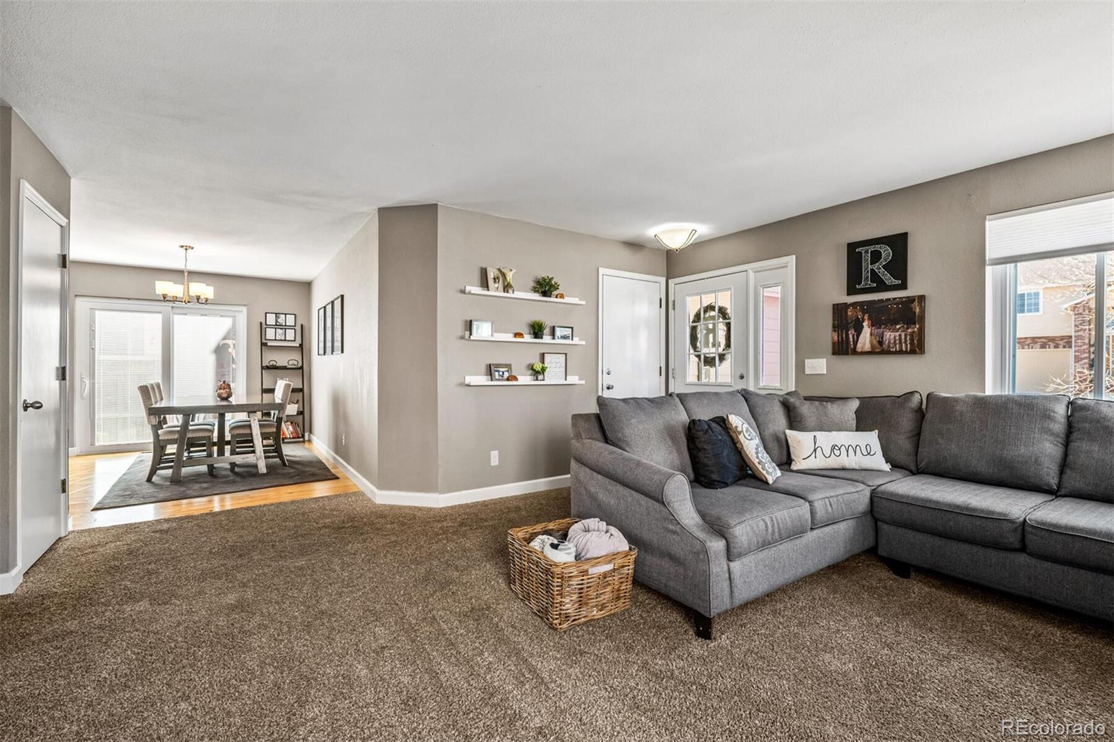 7670 Jared Way Littleton, CO 80125 - Photo 8 of 34 a living room with furniture and a large window