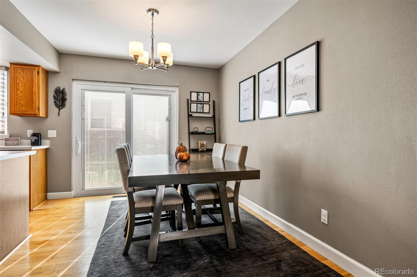 7670 Jared Way Littleton, CO 80125 - Photo 10 of 34 a view of a dining room with furniture window and wooden floor