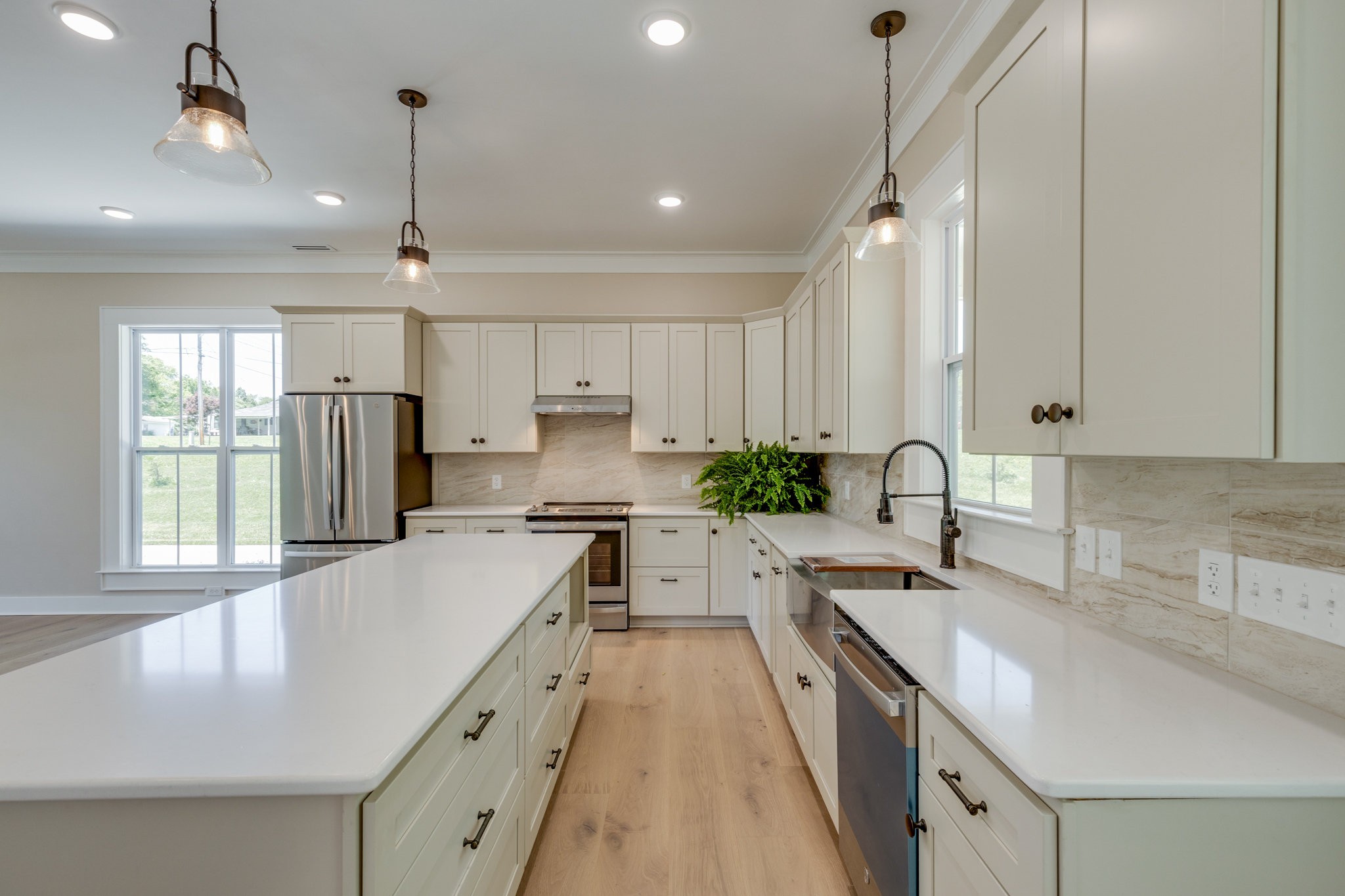 110 4th Avenue Loretto, TN 38469 - Photo 15 of 32 a kitchen with stainless steel appliances granite countertop sink stove and refrigerator