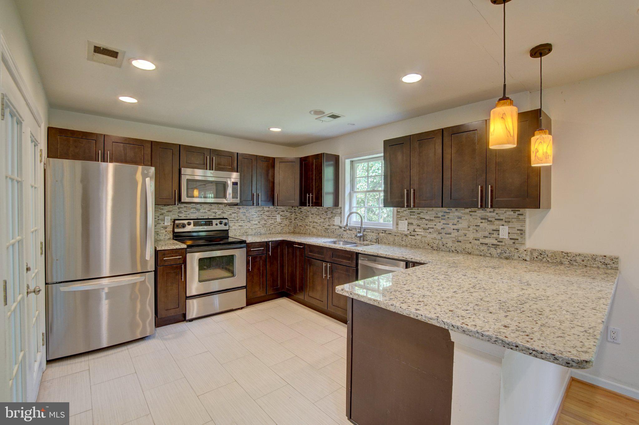 900 Walker Road Great Falls, VA 22066 - Photo 11 of 52 Modern kitchen with sleek finishes.