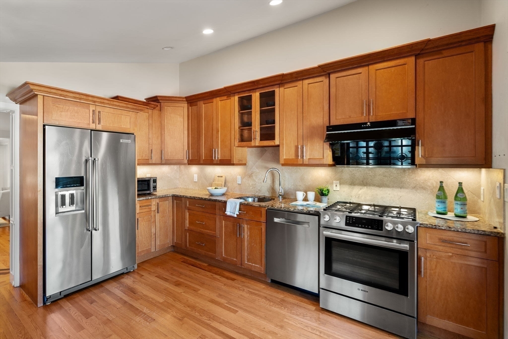 1844 Main Street, Unit 1 Concord, MA 01742 - Photo 2 of 36 a kitchen with stainless steel appliances granite countertop a refrigerator stove and sink