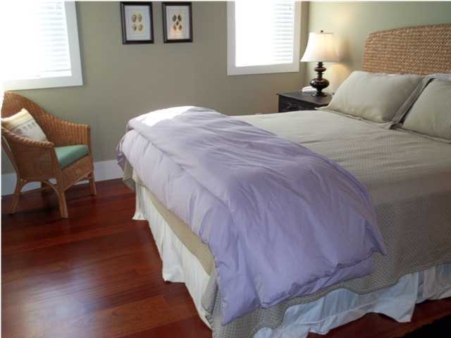 263 Winston Lane Inlet Beach, FL 32461 - Photo 11 of 21 a bedroom with a bed and a chair with wooden floor