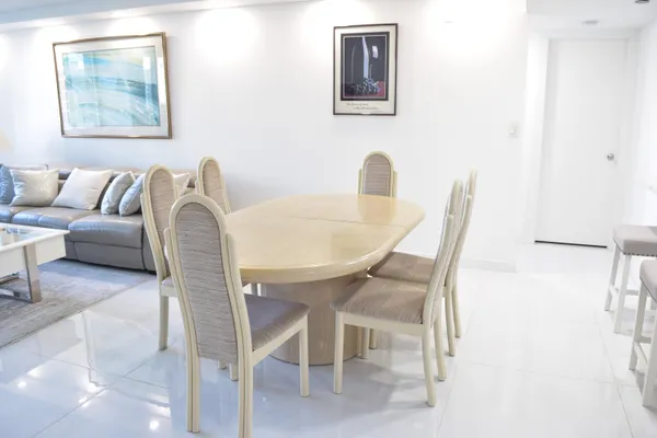a dining room with furniture and a wooden floor