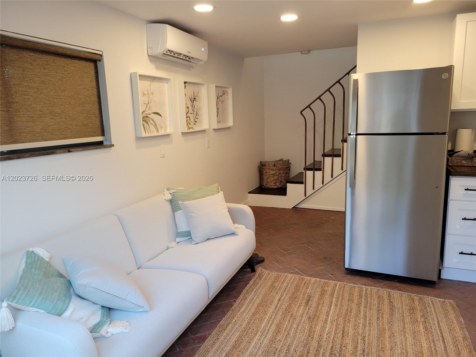 5866 Southwest 60th Street, Unit 3 Miami, FL 33143 - Photo 4 of 8 a living room with furniture and a refrigerator