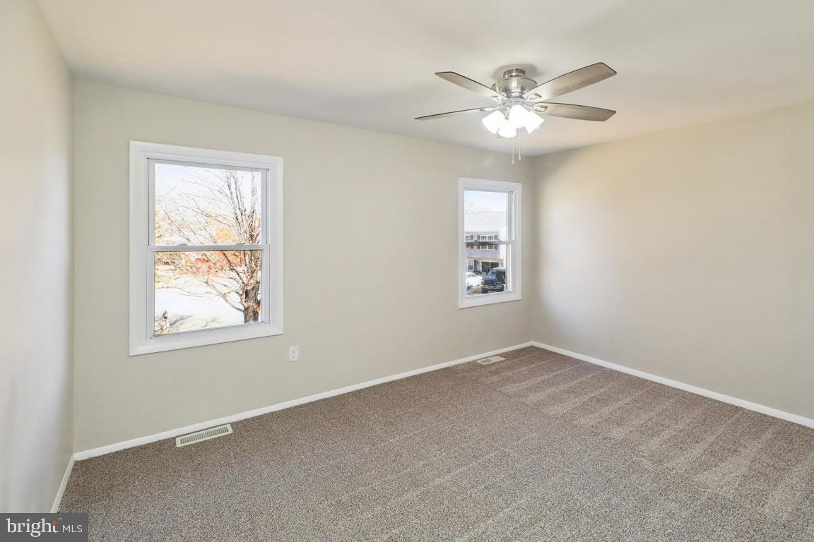 6551 Cornell Road Bryans Road, MD 20616 - Photo 14 of 25 an empty room with windows and fan
