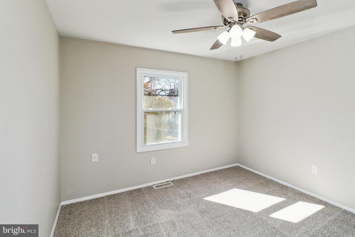 6551 Cornell Road Bryans Road, MD 20616 - Photo 16 of 25 an empty room with a window and a fan