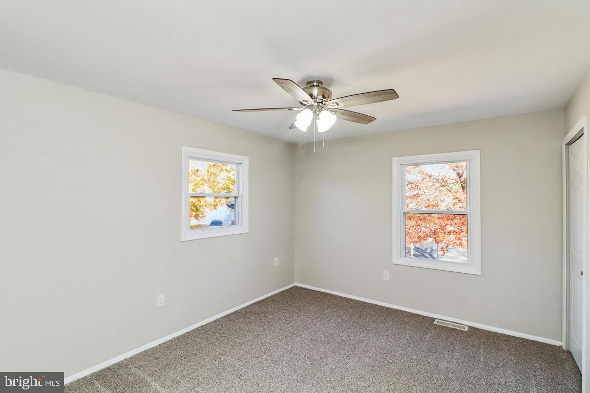 6551 Cornell Road Bryans Road, MD 20616 - Photo 18 of 25 an empty room with windows and fan