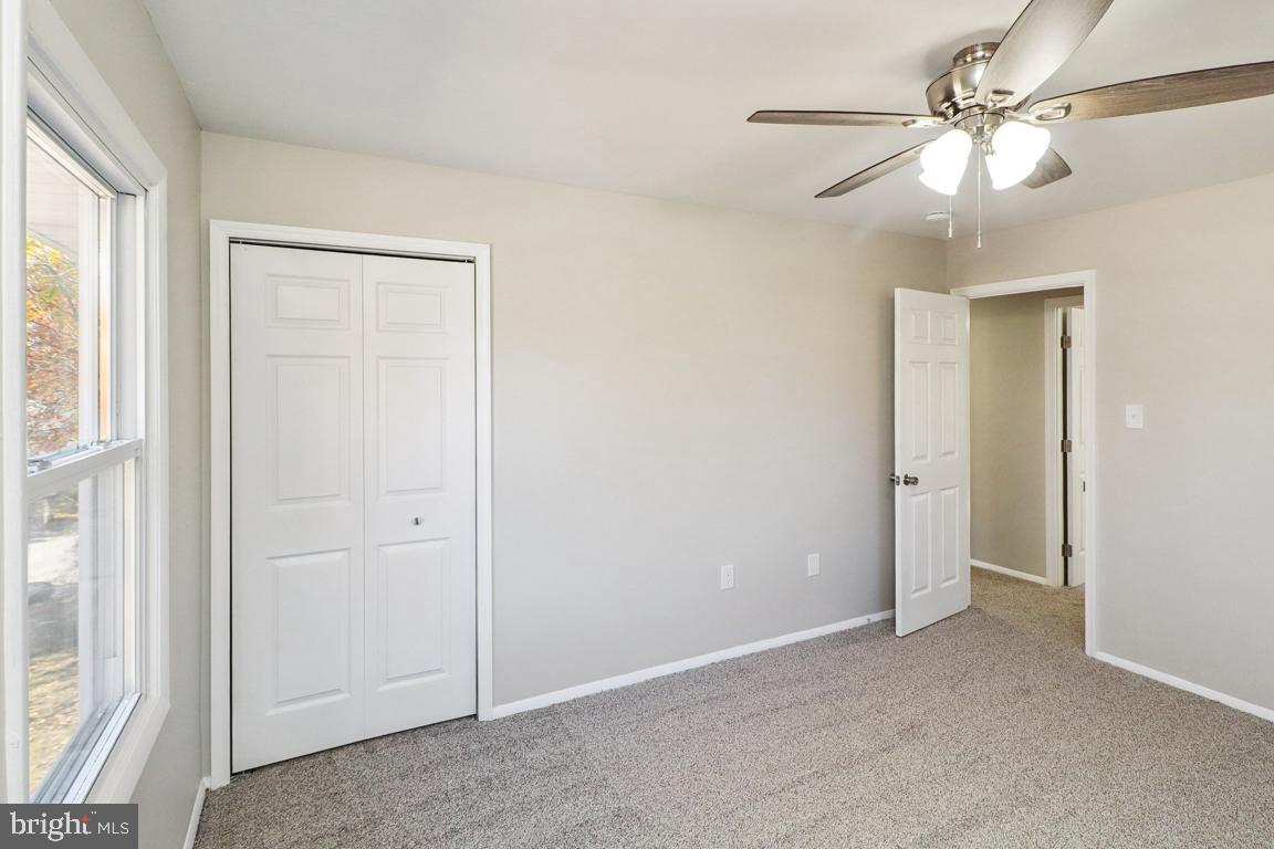6551 Cornell Road Bryans Road, MD 20616 - Photo 19 of 25 an empty room with windows and fan