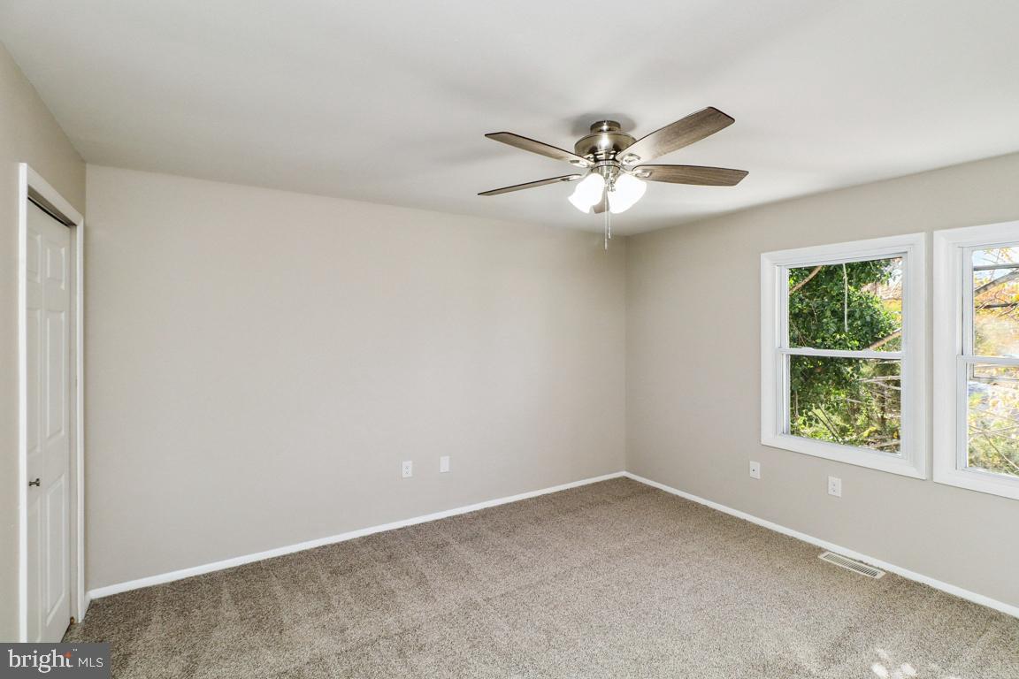 6551 Cornell Road Bryans Road, MD 20616 - Photo 20 of 25 an empty room with a window and a fan